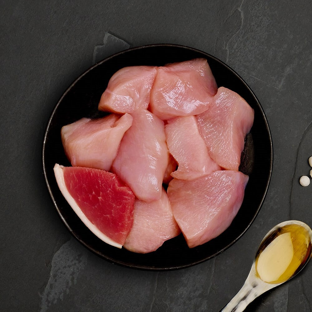 Fresh chicken and a slice of ham, the ingredients in Canagan Chicken with Ham for cats