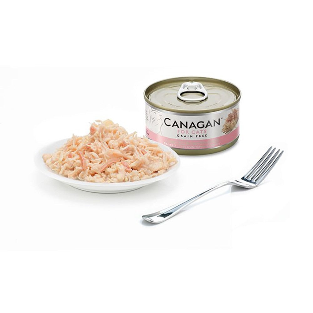 Canagan Chicken with Ham served on a plate beside the can, shredded chicken with pieces of ham in its own gravy