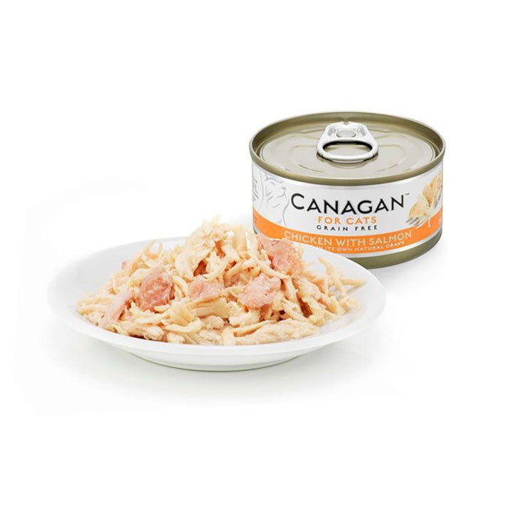 Canagan Chicken with Salmon served on a plate beside the can, shredded chicken with flakes of salmon in its own gravy