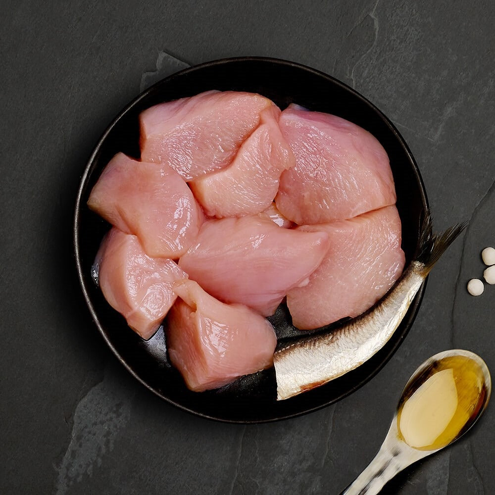 Fresh chicken and a whole sardine, the ingredients in Canagan Chicken with Sardine for cats