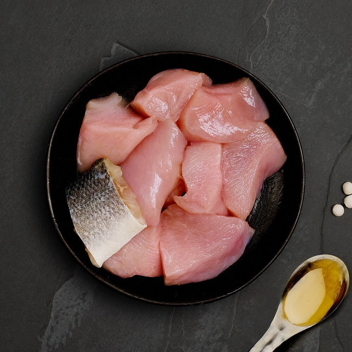Fresh chicken and a piece of seabass, the ingredients in Canagan Chicken with Seabass for cats