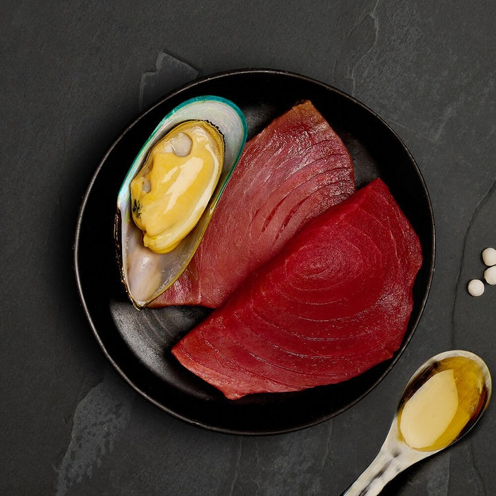 Fresh tuna steaks and a green lipped mussel, the ingredients in Canagan Tuna with Mussels for cats