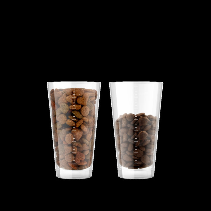 Feed up to 30 percent less: a glass of typical cheaper food beside a smaller glass of Canagan Salmon