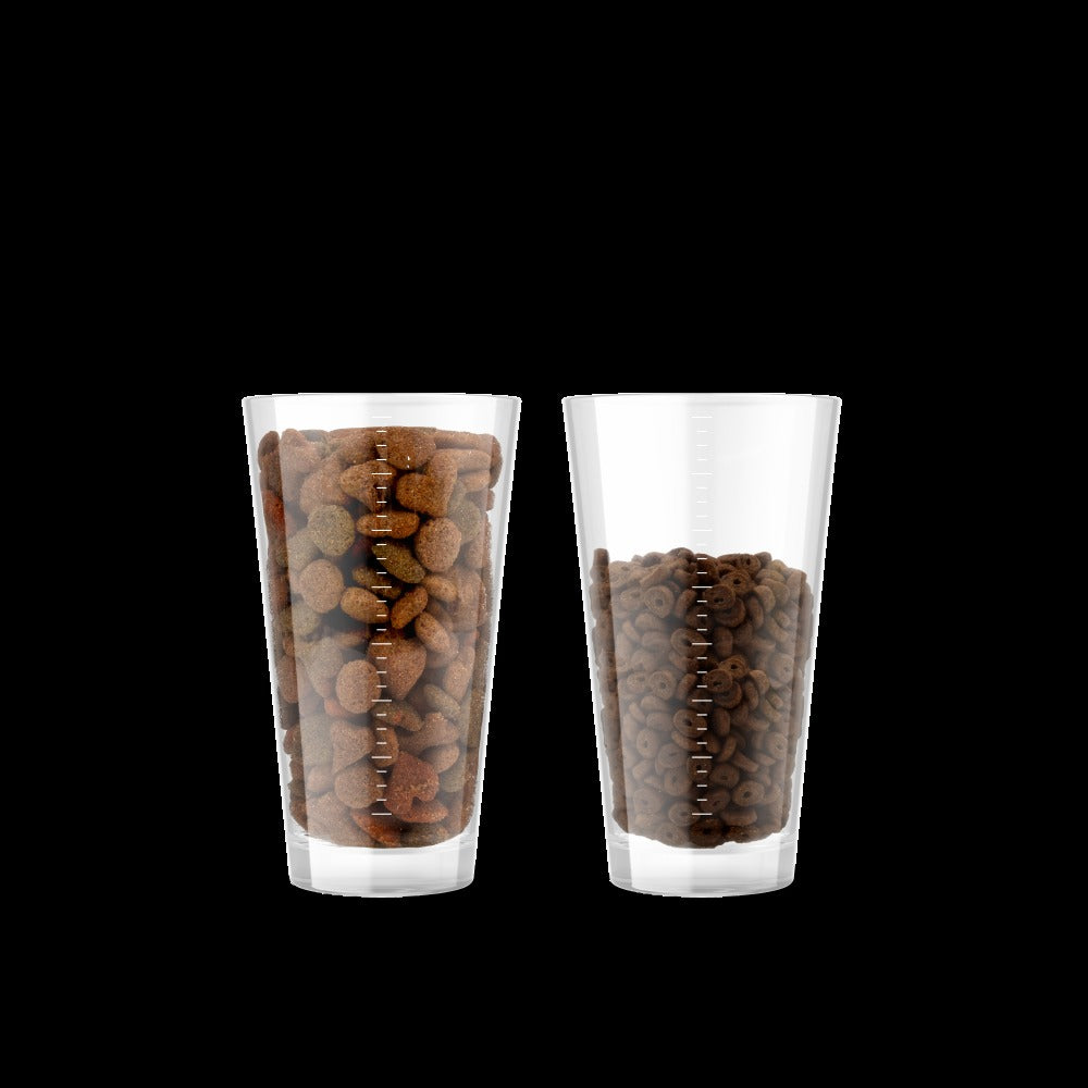 Feed up to 30 percent less: a glass of typical cheaper food beside a smaller glass of Canagan Small Breed Salmon